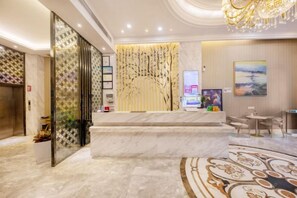 A hotel lobby with a marble reception desk, a staircase, and a chandelier. - Toronto Hotel (Majialong Hotel, Nantou Ancient Town) (Shenzhen)