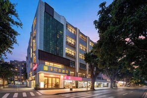 A multi-story hotel with a modern facade, large windows, and a visible ground-floor retail space. - Toronto Hotel (Majialong Hotel, Nantou Ancient Town) (Shenzhen)