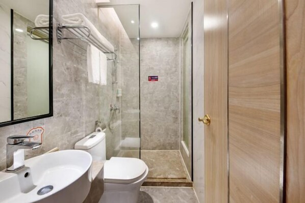 A modern bathroom with a glass shower enclosure, a white sink, and a toilet. - Toronto Hotel (Majialong Hotel, Nantou Ancient Town) (Shenzhen)