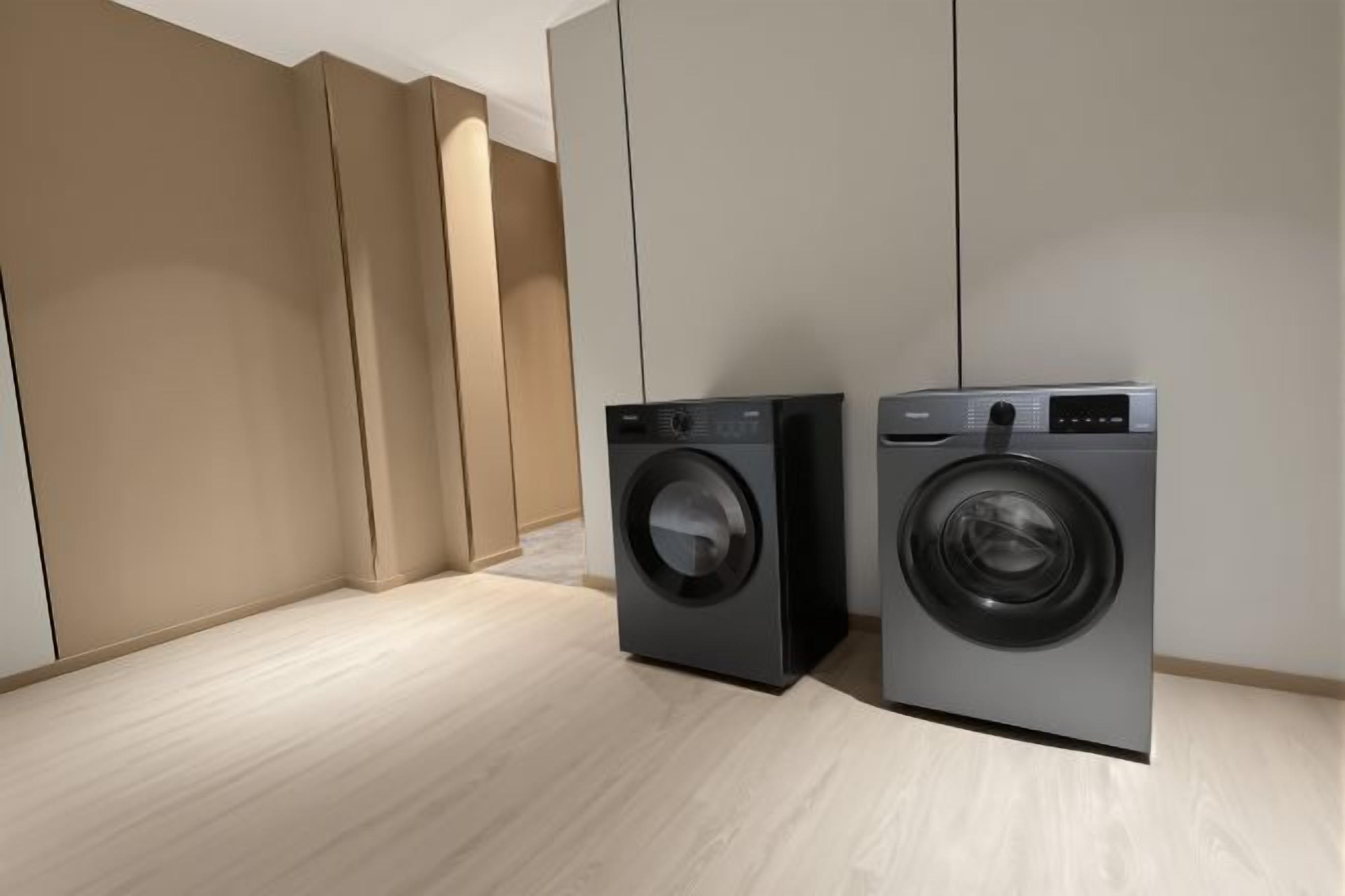 A modern laundry room with two front-loading washing machines.