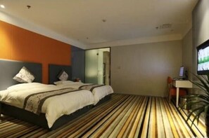 Relax in a spacious room with a large bed, desk, and TV.