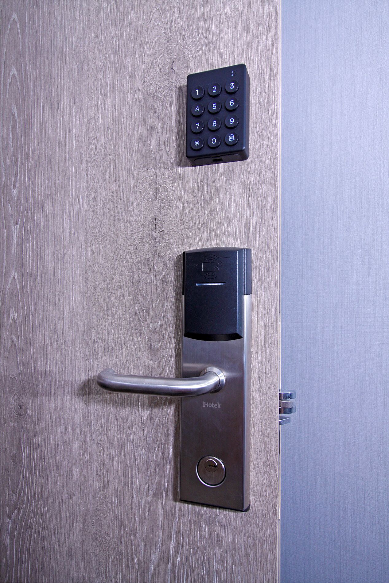 A modern door with a keyless entry system, including a keypad and a card reader.