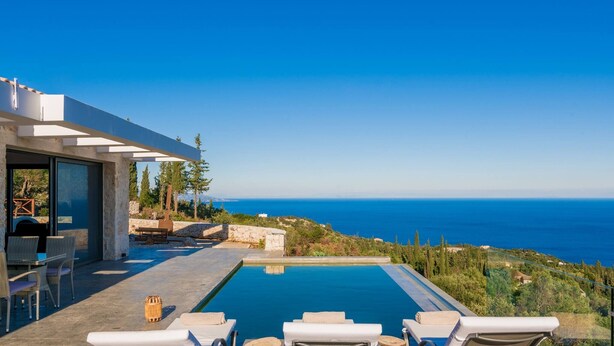 A modern villa with a pool, outdoor seating, and a view of the sea. - Nikolakos Villa - pirvate pool (Zakinthos)
