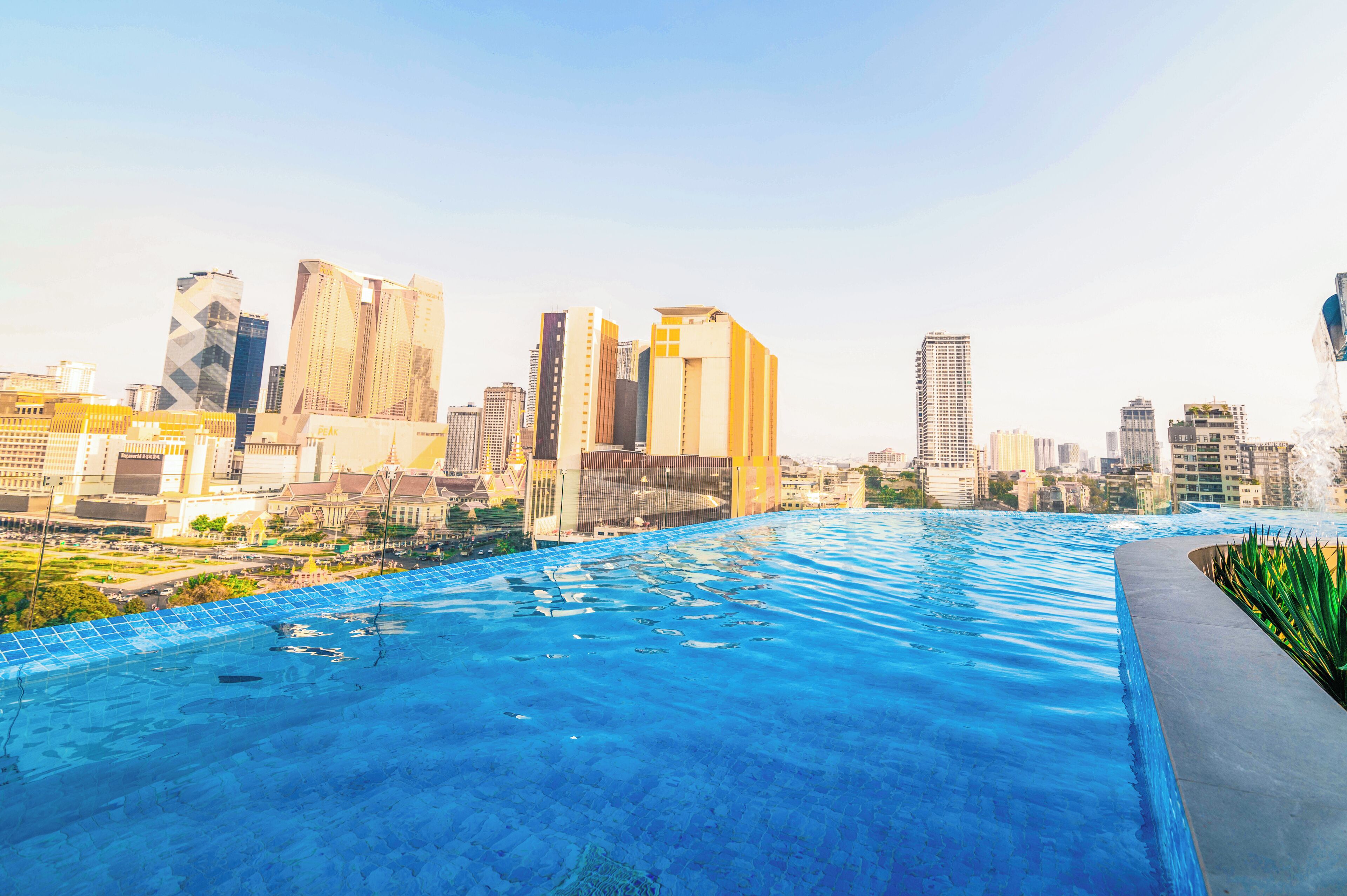 A rooftop infinity pool with a city skyline view.