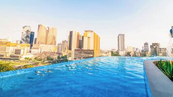 A rooftop infinity pool with a city skyline view.