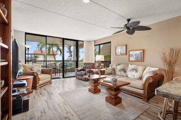 Space - Comfort - Ocean Views - Enjoy a spacious living room with AC. The open floor plan flowing from a large, well equiped kitchen onto the full width wrap-around lanai.