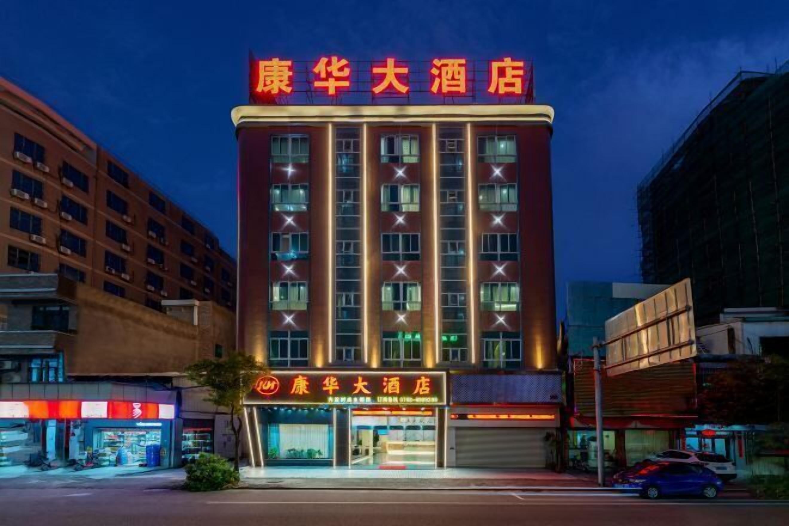 A hotel with a prominent red sign, multiple floors, and a modern facade.