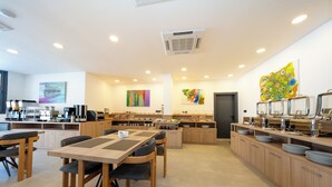 A modern kitchen with wooden cabinets, a central island, and a buffet setup. - Skykhan Otel (Fethiye)