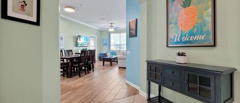 A dining area with a wooden table and chairs, a sofa, and a coffee table.