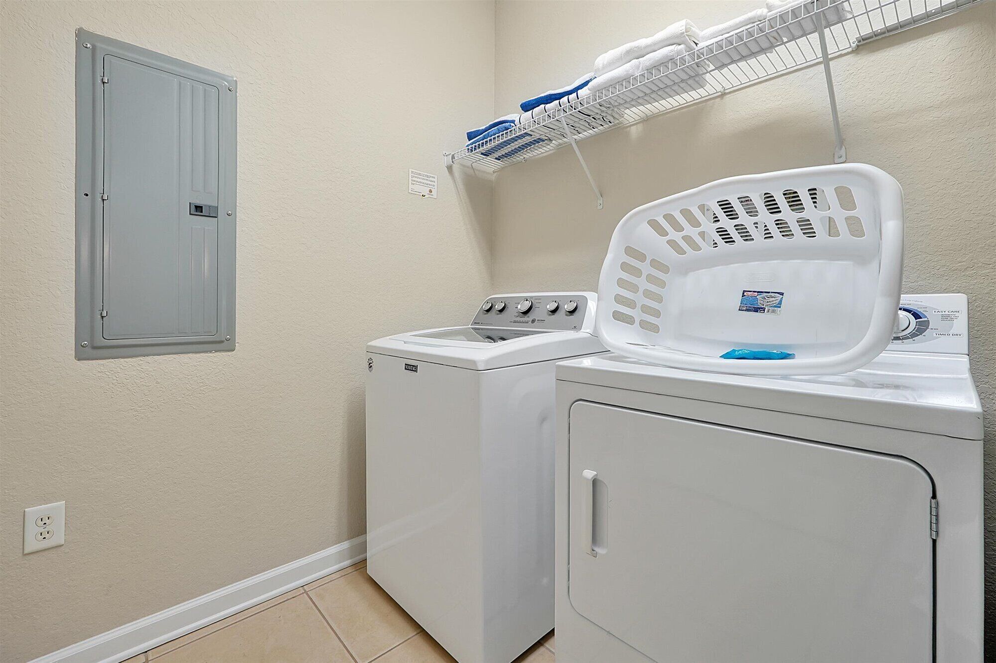 A laundry area with a washing machine, dryer, and a drying rack.