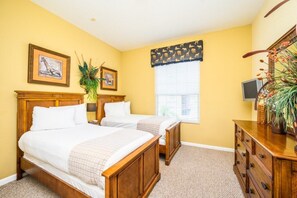 A hotel room with two beds, a wooden dresser, a television, and a window with blinds. - Tropical Lakeview Condo w. Vegas Game Room - 1014 (Orlando)