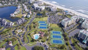 An aerial view of a coastal resort with multiple buildings, a beach, and a lake. - Overlooking Saltwater Lake & near beach, 1 Minute to Pool! (Pawleys Island)