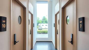 A hotel hallway with doors labeled 'VIP 10' and 'VIP 7' leading to rooms.