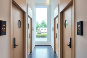 A hotel hallway with doors labeled 'VIP 10' and 'VIP 7' leading to rooms. - Kant's Apartment Hotel (Zhuhai)