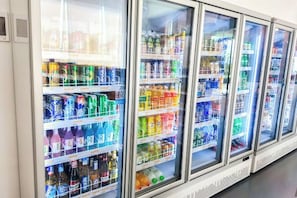 Een rij gekoelde drankdispensers, gevuld met verschillende soorten drank.