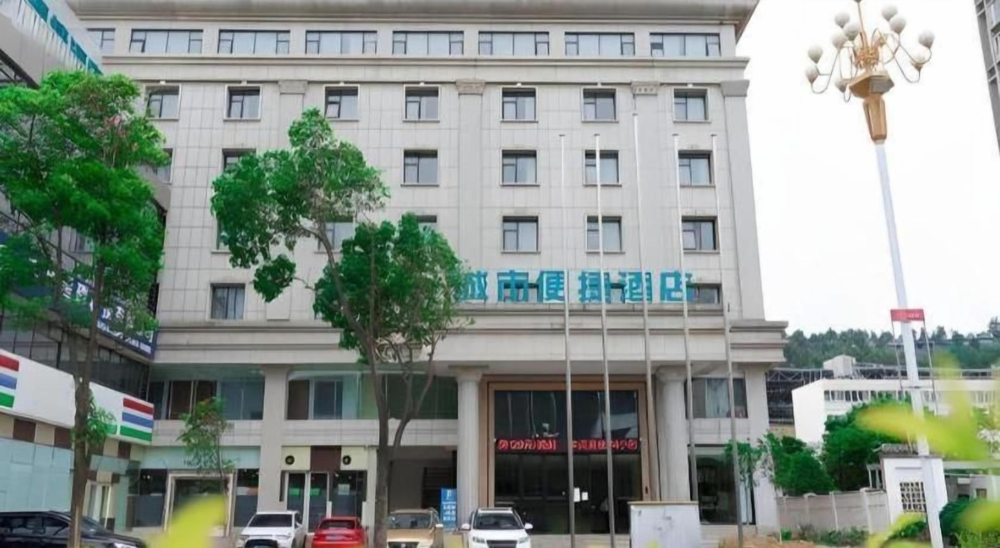 A multi-story building with a sign indicating it is a hotel.
