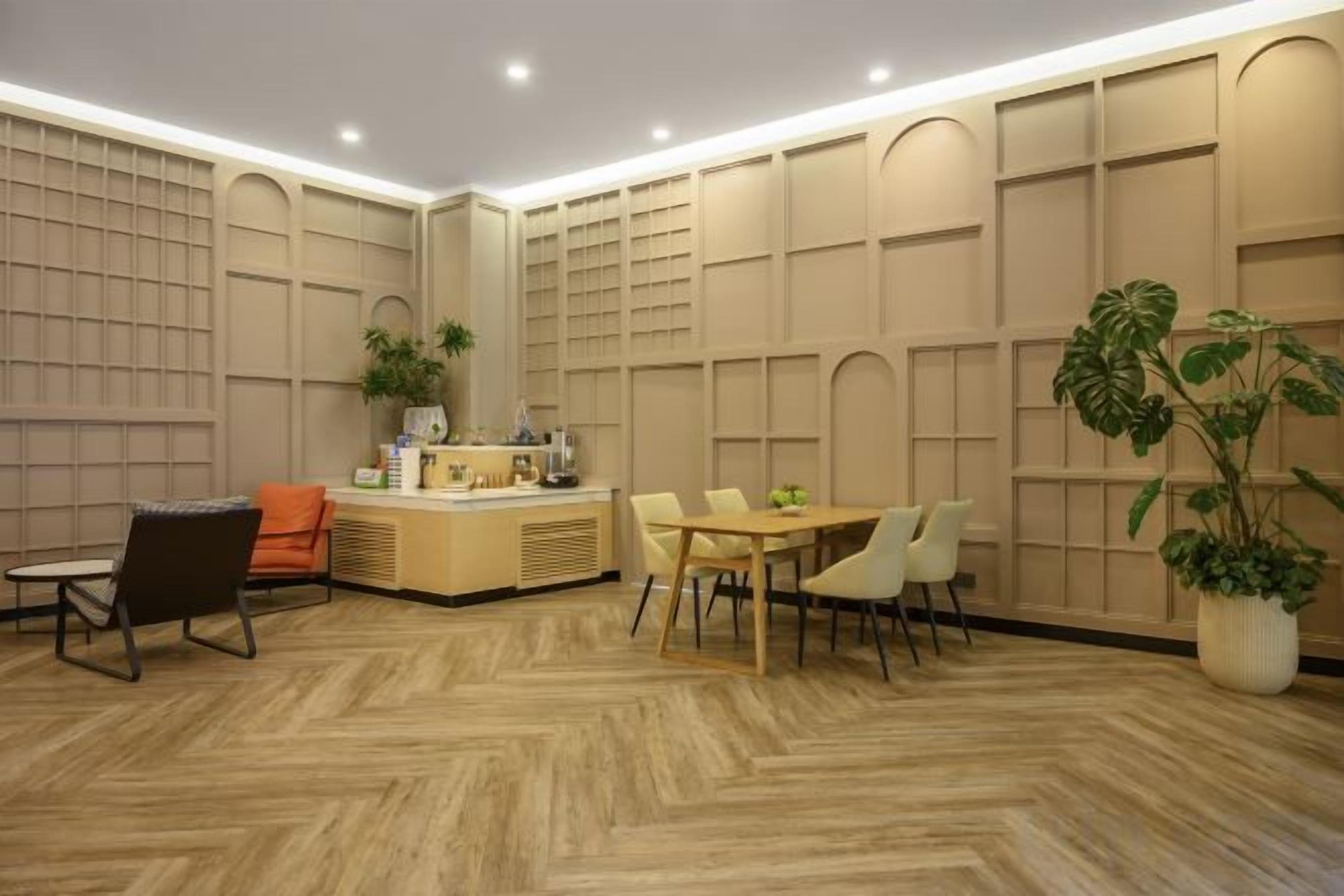A modern interior with a reception desk, seating area, and decorative wall panels.