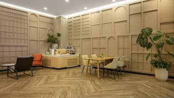 A modern interior with a reception desk, seating area, and decorative wall panels.