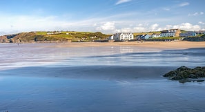 A coastal beach scene with houses in the background. - Atlantic Sunset, Holiday Home Little Haven, Sleeps 12, 6 bedrooms,  bathrooms (Little Haven)