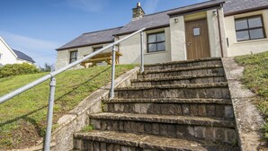 A stone staircase leading to a house with a wooden door and windows. - Coastal View, Holiday Cottage Porthgain, Sleeps 4, 2 bedrooms,  bathrooms (Haverfordwest)