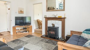 A living room with a television, fireplace, and a mirror on the wall. - Glen Holme, Holiday Apartment Little Haven, Sleeps 3, 1 bedrooms,  bathrooms (Little Haven)