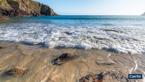 A beach with clear water, rocks, and a cliff. - Gorwel, Holiday Home St Davids, Sleeps 6, 3 bedrooms,  bathrooms (Haverfordwest)
