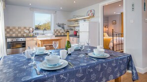 A compact kitchen with a dining area set for a meal.
