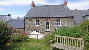 A stone house with a sloped roof, two chimneys, and a small porch. - Greystones House, Holiday Home St Davids, Sleeps 6, 3 bedrooms,  bathrooms (Haverfordwest)