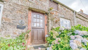A stone building with a wooden door, a plaque, and a window. - Honey Hook Cottage, Holiday Cottage Nolton, Sleeps 5, 2 bedrooms,  bathrooms (Haverfordwest)