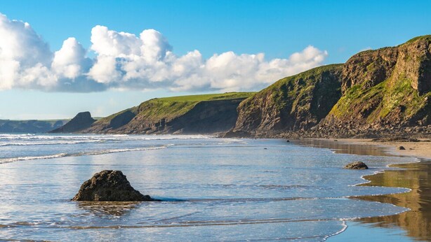 A coastal landscape with cliffs, a beach, and a large rock in the water. - Honey Hook Cottage, Holiday Cottage Nolton, Sleeps 5, 2 bedrooms,  bathrooms (Haverfordwest)