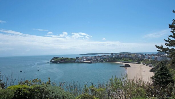 A coastal town with a sandy beach, a pier, and a church. - Inglenook House, Holiday Home Manorbier, Sleeps 8, 4 bedrooms,  bathrooms (TENBY)