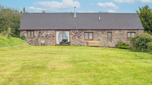 A stone building with a sloped roof, a front door, and two windows. - Kingfisher Cottage, Holiday Cottage St Ishmaels, Near Dale, Sleeps 4, 2 bedrooms,  bathrooms (Haverfordwest)