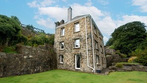 A stone building with a chimney, a door, and a window. - Lower Coach House, Holiday Home Fishguard, Sleeps 2, 1 bedrooms,  bathrooms (Fishguard)