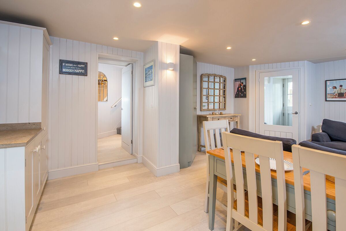 A cozy interior with a dining area, kitchen, and a living space.