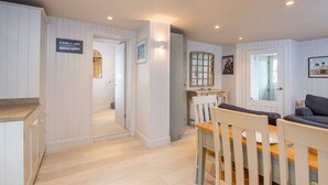 A cozy interior with a dining area, kitchen, and a living space. - Lower Deck, Holiday Apartment Tenby, Sleeps 2, 1 bedrooms,  bathrooms (Tenby)