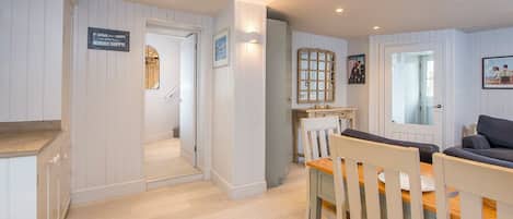 A cozy interior with a dining area, kitchen, and a living space.