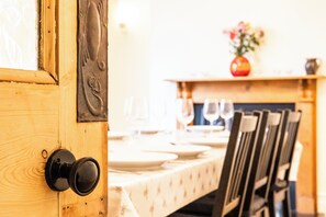 Enjoy meals in this dining area with a table set for a meal, surrounded by comfortable chairs.