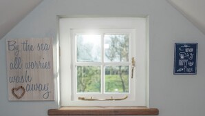 A room with a white door, a wooden plaque with a heart and text, and a framed sign on the wall. - Swallows Rest, Holiday Home Croesgoch, Sleeps 6, 3 bedrooms,  bathrooms (Croesgoch)