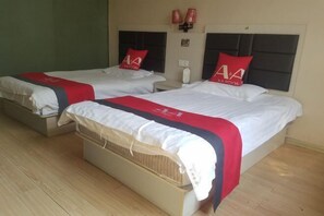 A hotel room with two beds, each with a red and white bedspread and matching pillows. - AA Room (Suzhou)