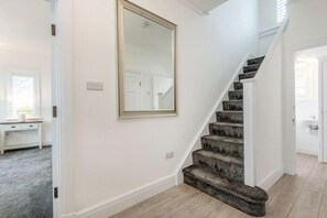A staircase with carpeted steps leading to a second-floor landing. - The Rath, Holiday Cottage Saundersfoot, Sleeps 6, 3 bedrooms,  bathrooms (SAUNDERSFOOT)