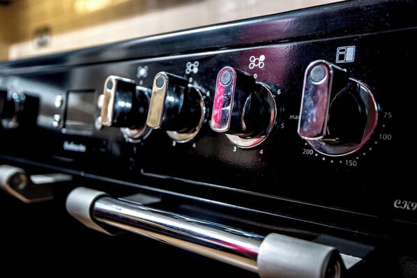 A stove with control knobs and a digital display.