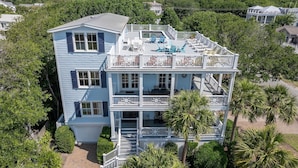 A multi-story house with a balcony and a garage.