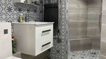 Shower, hair dryer, towels, toilet paper