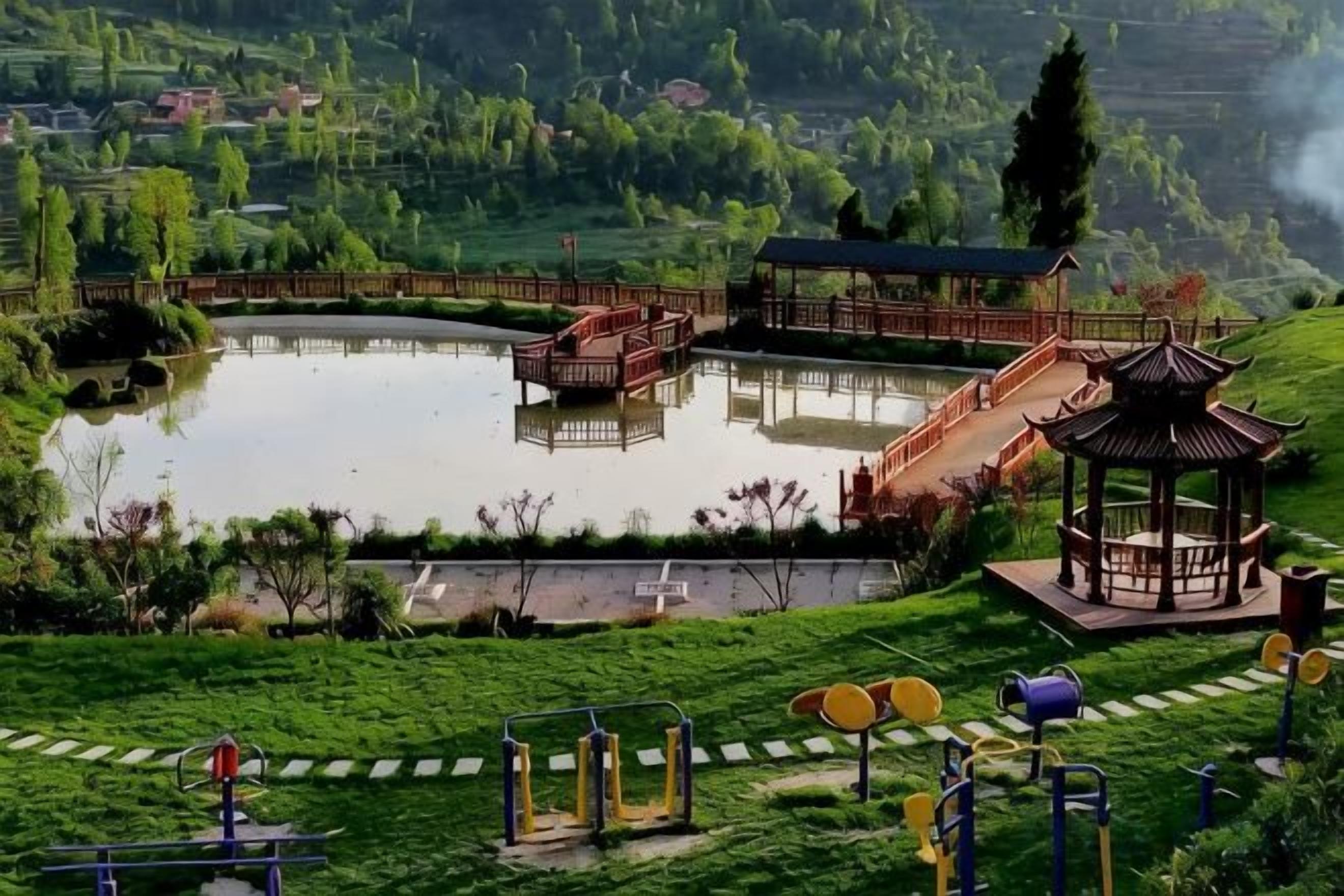 A park with a pond, exercise equipment, a gazebo, and a pavilion.