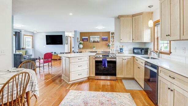 A modern kitchen with wooden cabinets, a stainless steel oven, and a microwave. - Views of Canandaigua Lake: Middlesex Retreat! (Rushville)