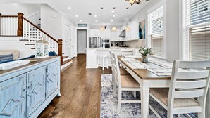 A spacious kitchen with a central island, white cabinetry, and a chandelier. - ☀️6-Seater Golf Cart-4BR-Pet Friendly-Bikes-Our Gulfview Escape (Santa Rosa Beach)