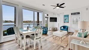 A spacious living area with a dining table, chairs, and a sofa. - ☀️Waterfront Villa-Gulf Views-Pool-Totally Updated-4BR Destiny Beach Villas 15☀️ (Destin)