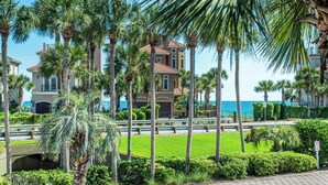 A beachfront property with a large house, palm trees, and a clear view of the ocean. - ☀️Waterfront Villa-Gulf Views-Pool-Totally Updated-4BR Destiny Beach Villas 15☀️ (Destin)