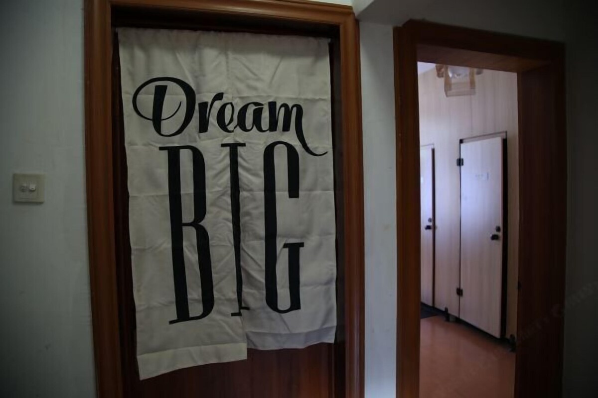 A hallway with a door leading to another room.