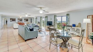 A spacious living room with a sofa, dining table, chairs, and a ceiling fan. - Oceanfront Flagler Beach Home w/ Decks & Gas Grill (Flagler Beach)